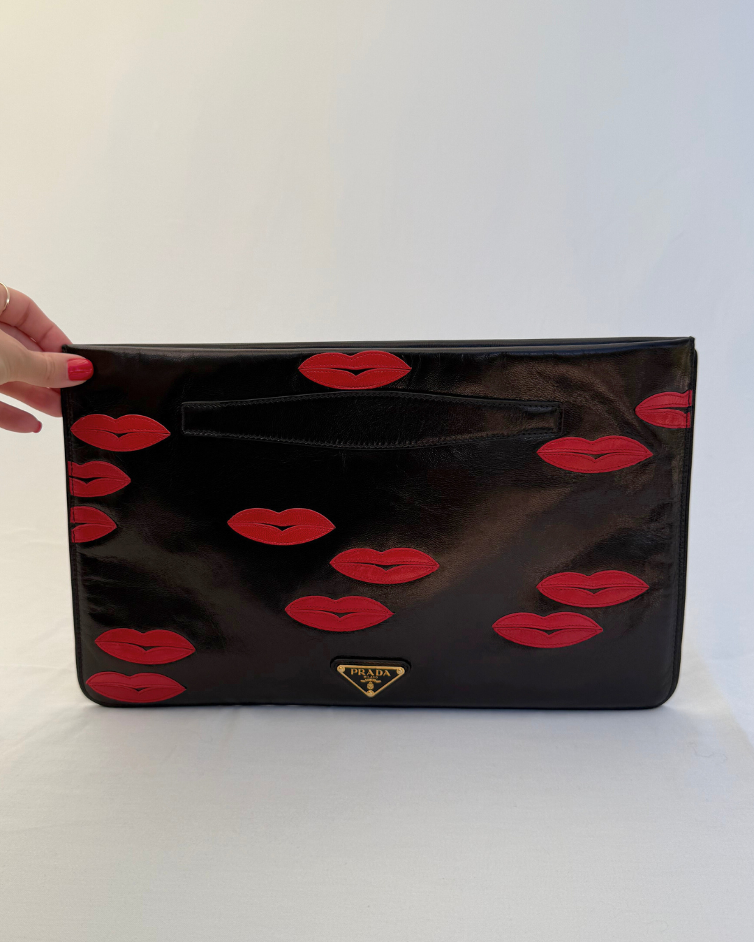 Front view of Prada Madras Leather Lips Clutch red and black lips graphic vintage handbag