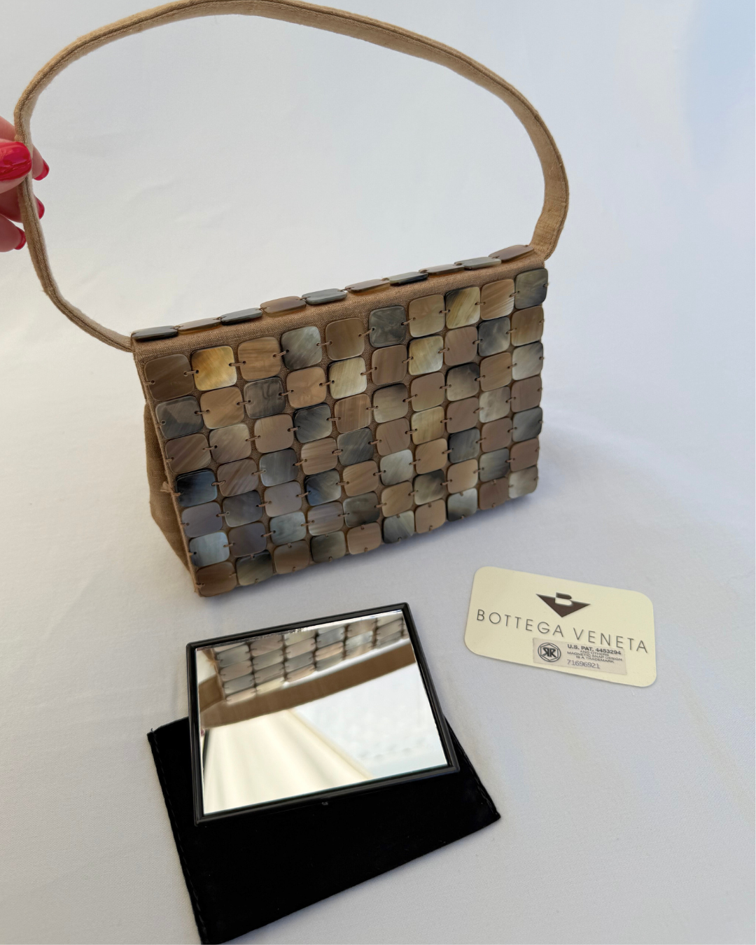 Front detail image of the Front view of the Bottega Veneta 1997 Rare Vintage Canvas Top Handle Bag neutral mother of pearl detailing with the original Authenticity Card and original compact mirror