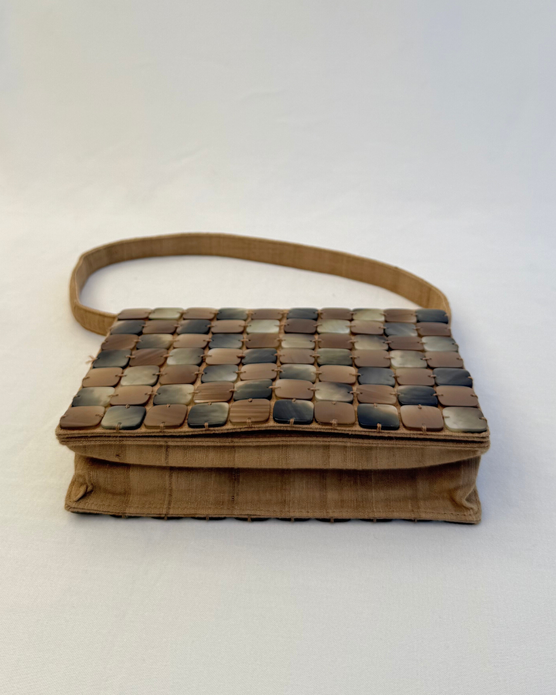 Bottom view of the Bottega Veneta 1997 Rare Vintage Canvas Top Handle Bag neutral mother of pearl detailing