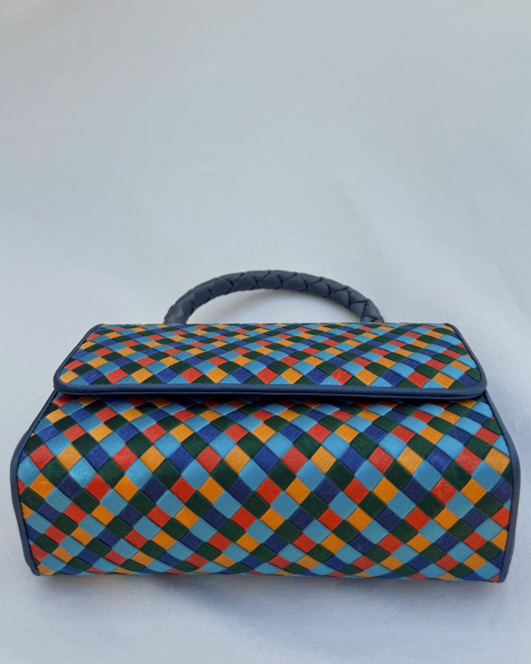 Colorful checkered Bottega Veneta handbag on a white background bottom view