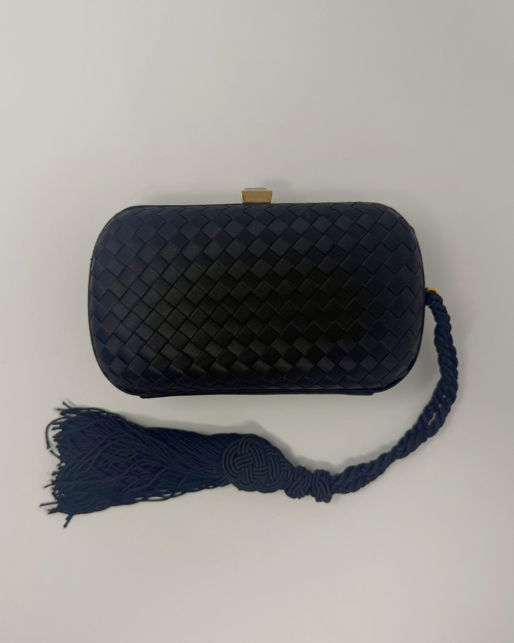 Tassel clutch black vintage bottega veneta intrecciato on white background