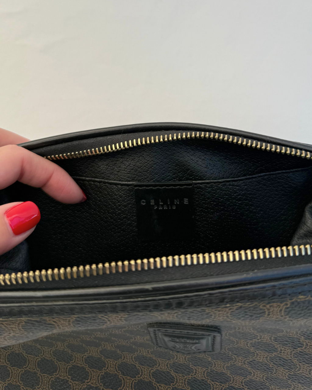 Inside view of Celine Vintage Macadam Portfolio Brown Cosmetic Bag leather lining on white background