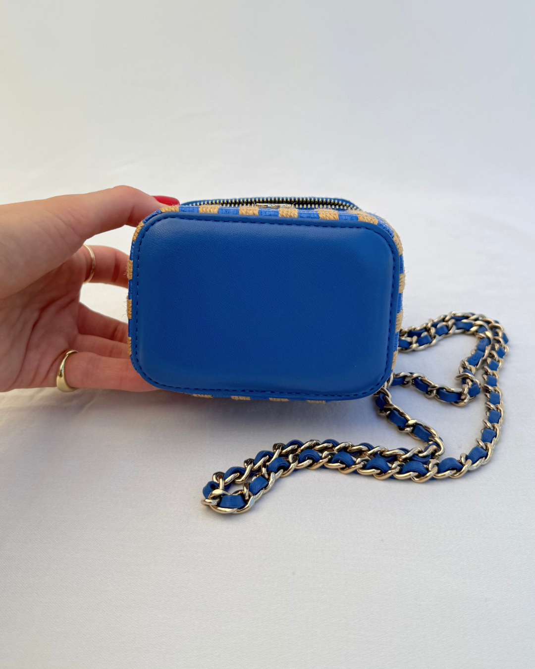 Bottom view of Chanel 2021 Raffia Mini Vanity Case blue and raffia striped leather pre-loved vintage handbag on a white background