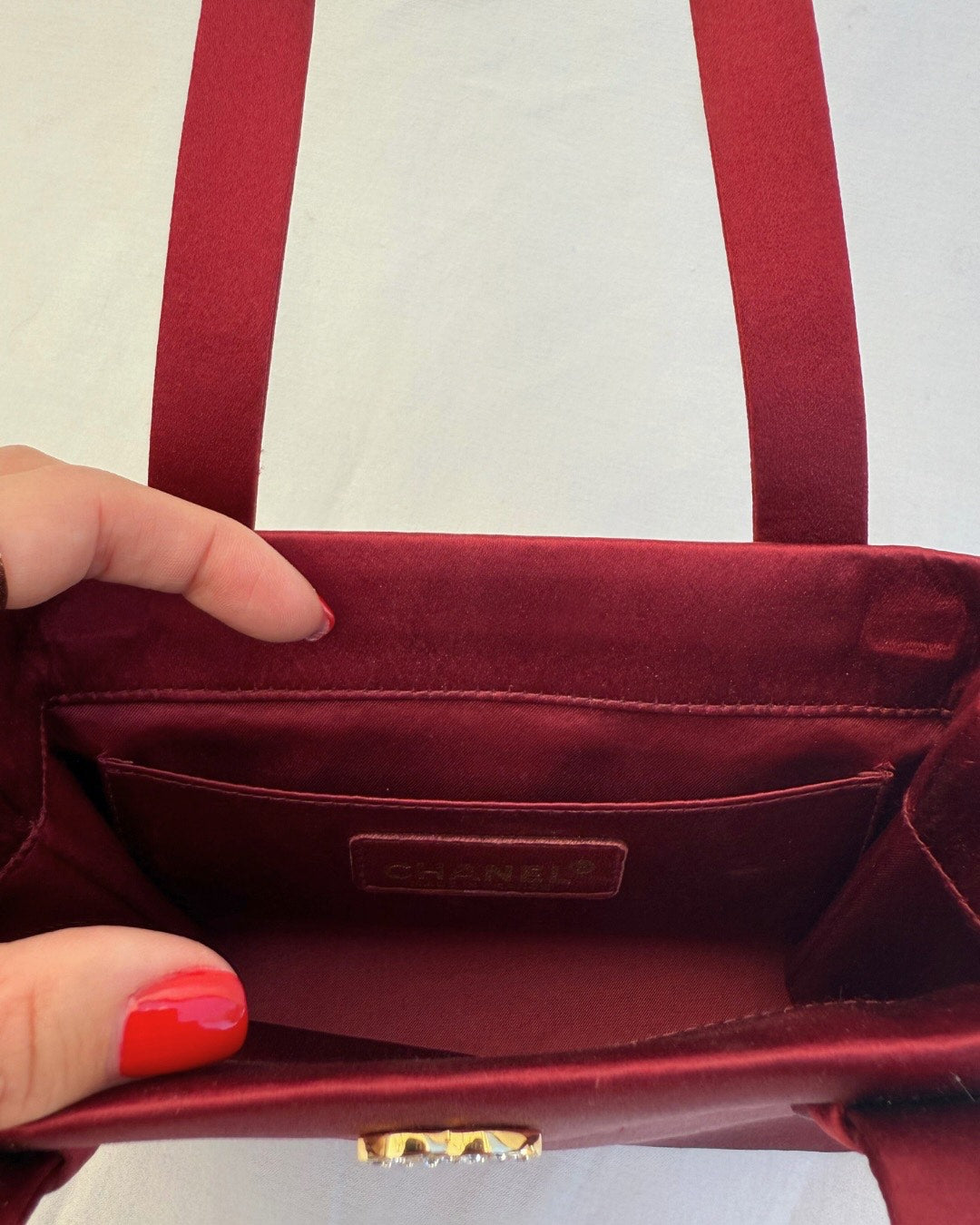 Inside view of Chanel Rare Vintage 1990's Red Satin Evening Bag vintage handbag on white background