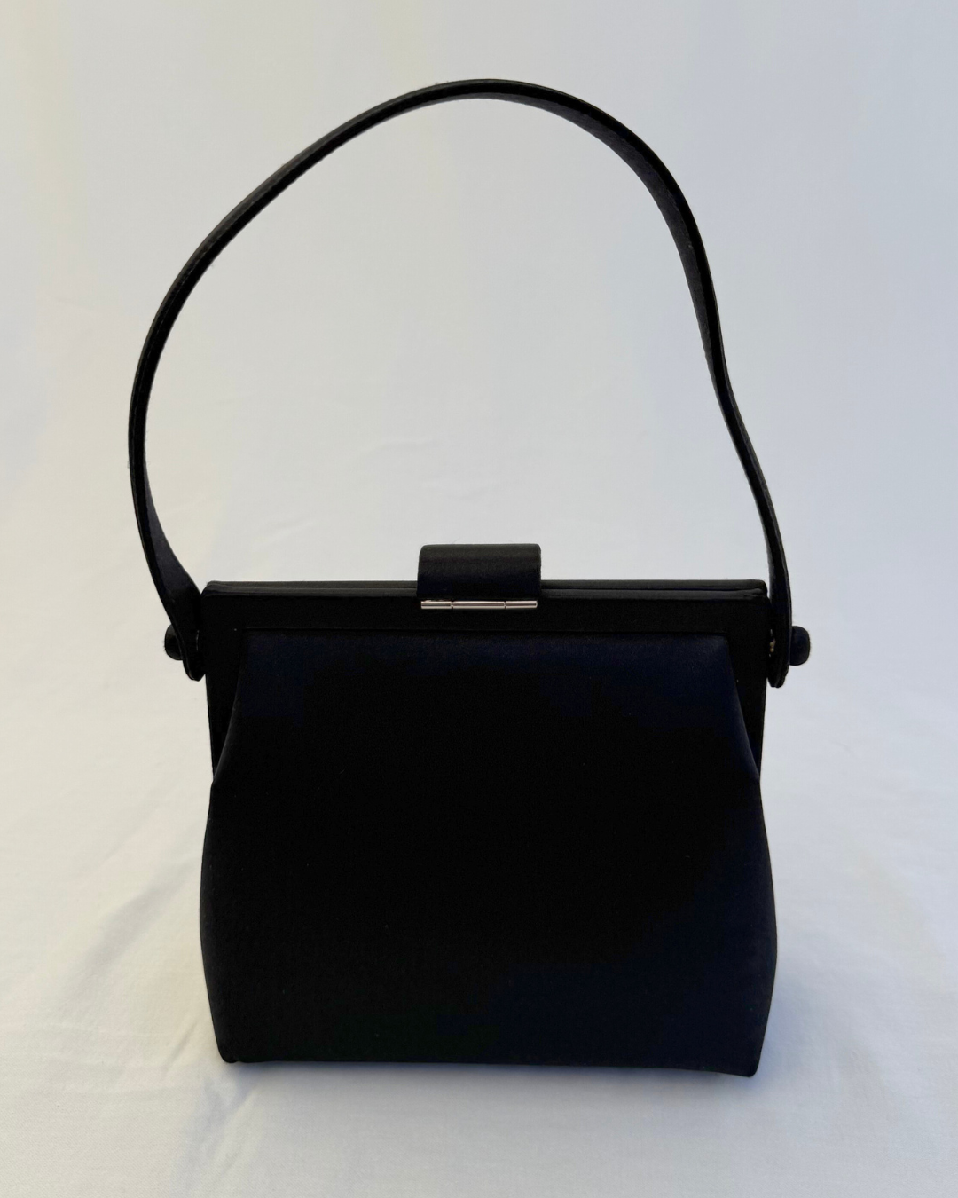 Back detail view of Chanel Rare Vintage 1997 Mini Black Satin Frame Evening Bag on white background