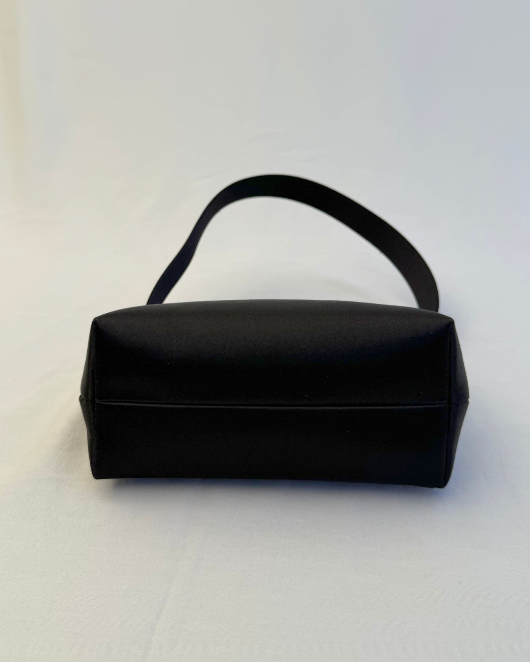 Bottom view of Chanel Rare Vintage 1997 Mini Black Satin Frame Evening Bag on white background