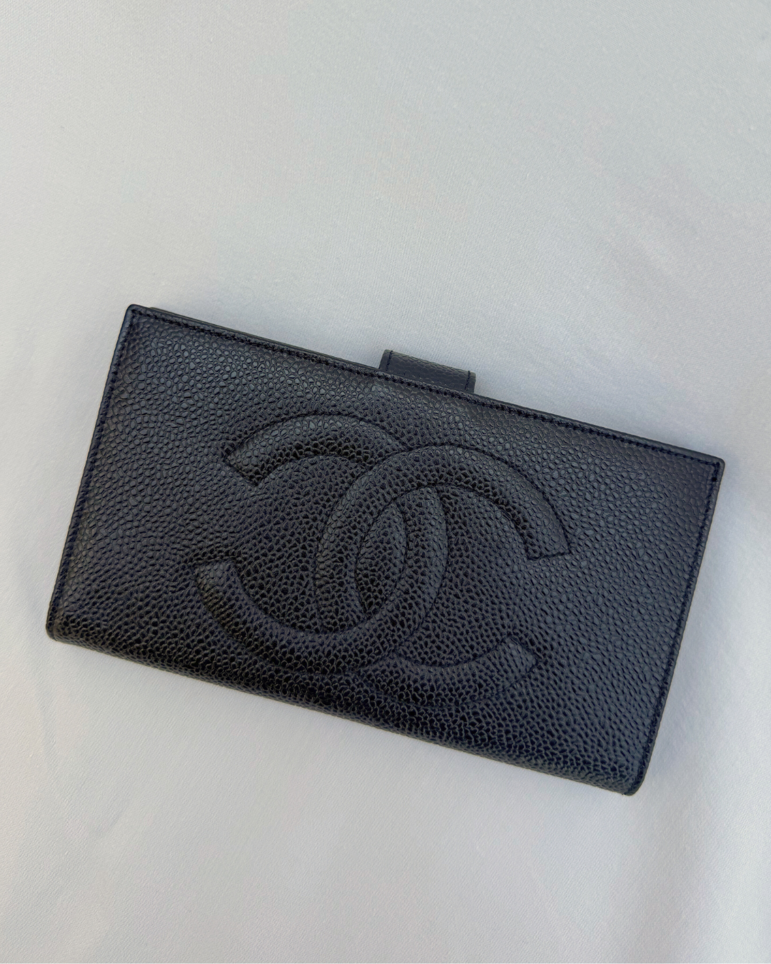 Black Chanel wallet on a white background top view