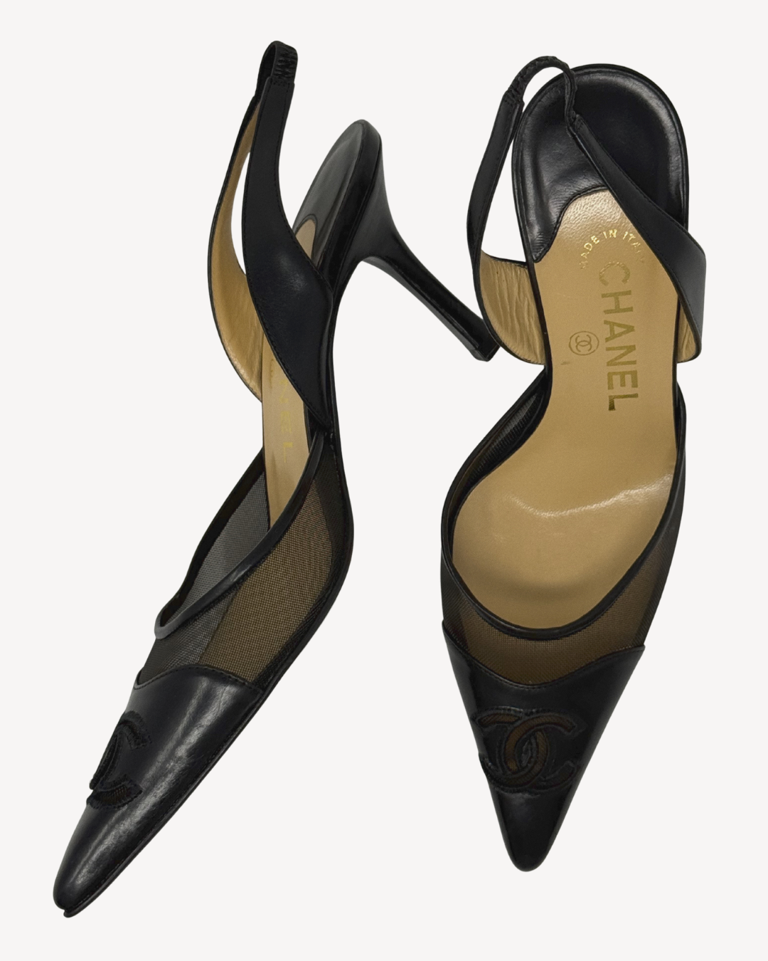 Black high-heeled shoes with Chanel logo on a white background