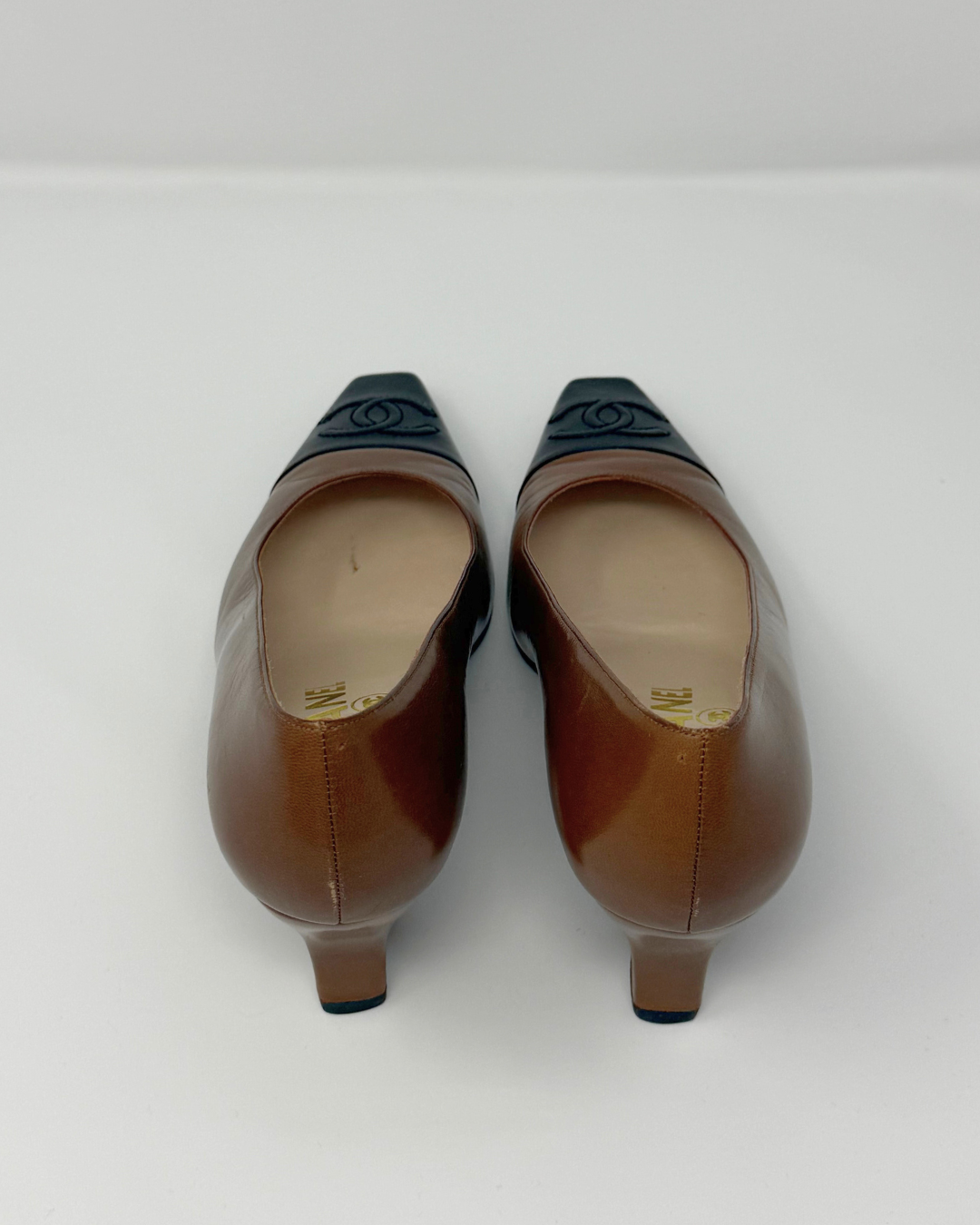 Pair of brown high-heeled shoes on a white background