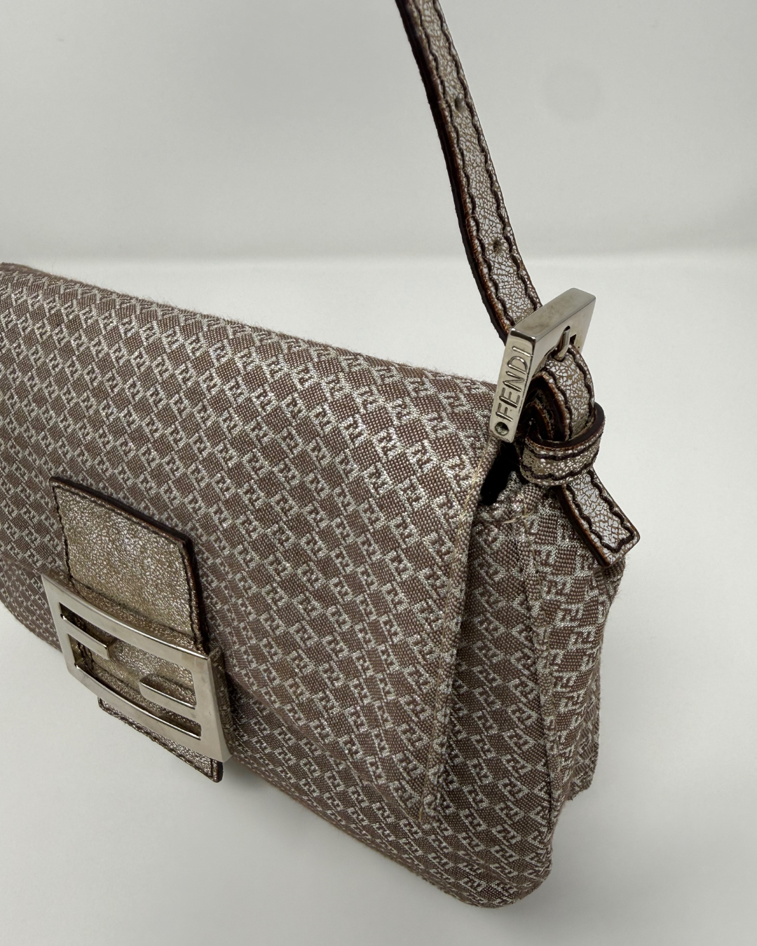 Patterned Fendi vintage handbag with a metallic clasp on a light gray background