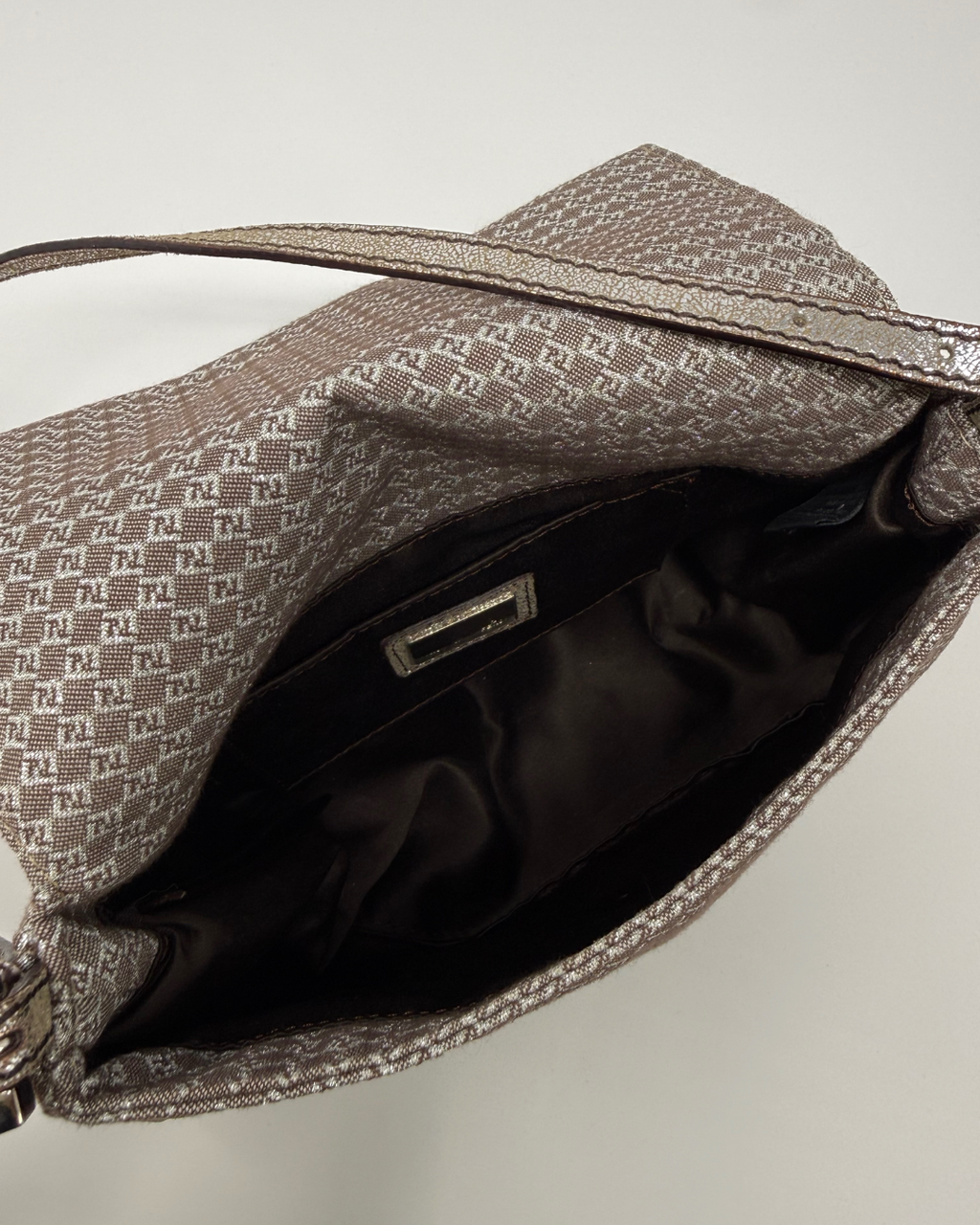 Silver and grey patterned Fendi Vintage handbag with open front pocket on a light gray background
