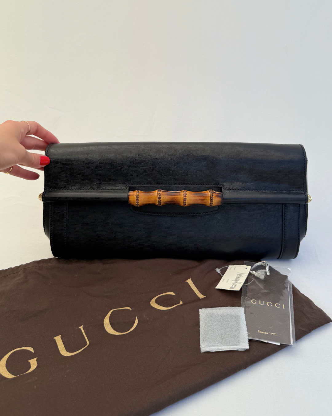 Front view of Gucci Vintage Black Leather & Bamboo Clutch with original dust cover and tags on white background