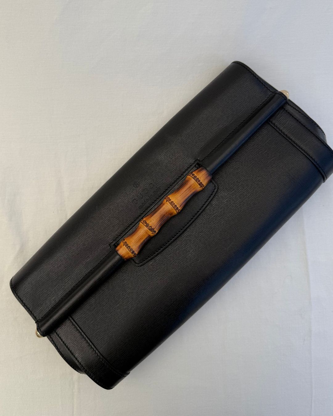 Top view of Gucci Vintage Black Leather & Bamboo Clutch on white background