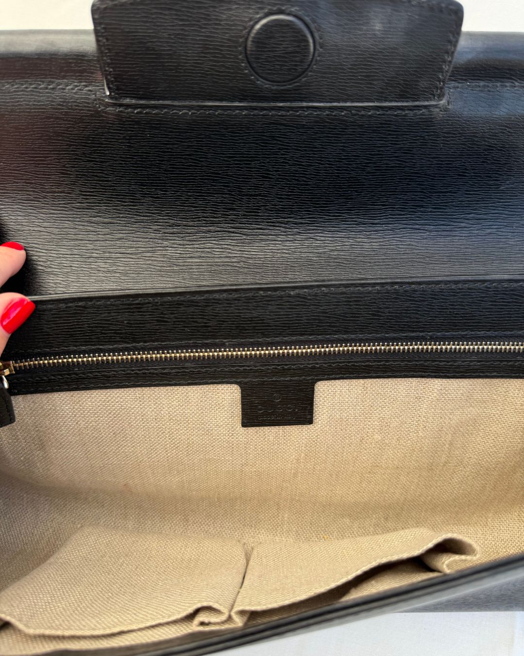 Inside view of Gucci Vintage Black Leather & Bamboo Clutch linen and leather lining on white background