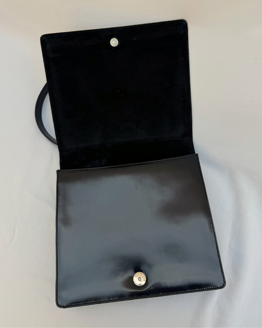 Black leather Gucci by Tom Ford vintage handbag on a white background open inside view with magnetic snap closure