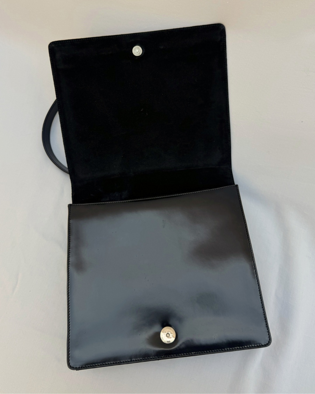 Black leather Gucci by Tom Ford vintage handbag on a white background open inside view with magnetic snap closure