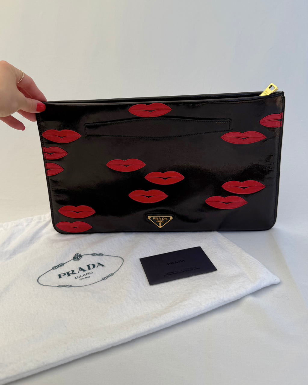 Front view of Front view of Prada Madras Leather Lips Clutch red and black lips graphic vintage handbag with original dust cover