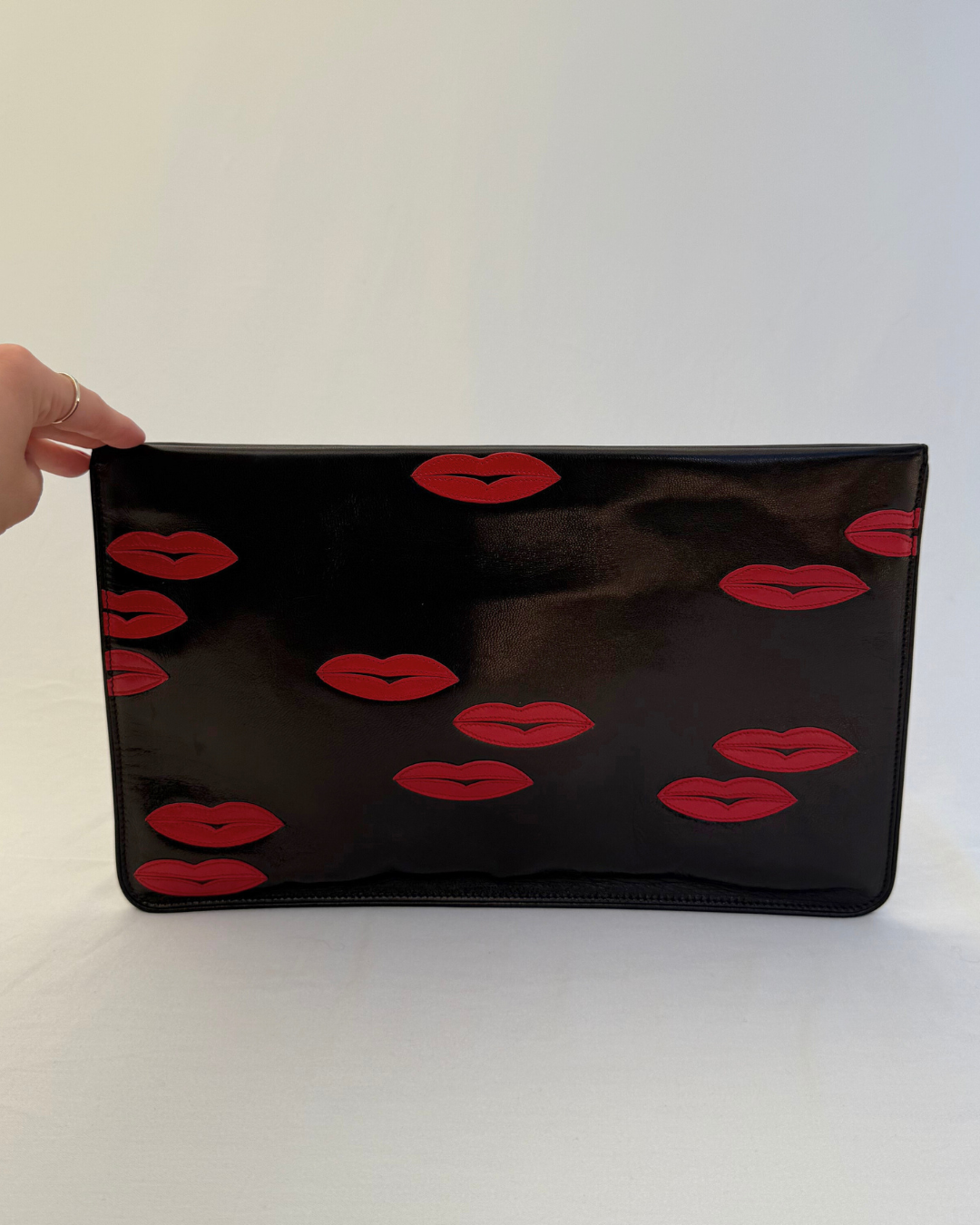 Back view of Prada Madras Leather Lips Clutch red and black lips graphic vintage handbag
