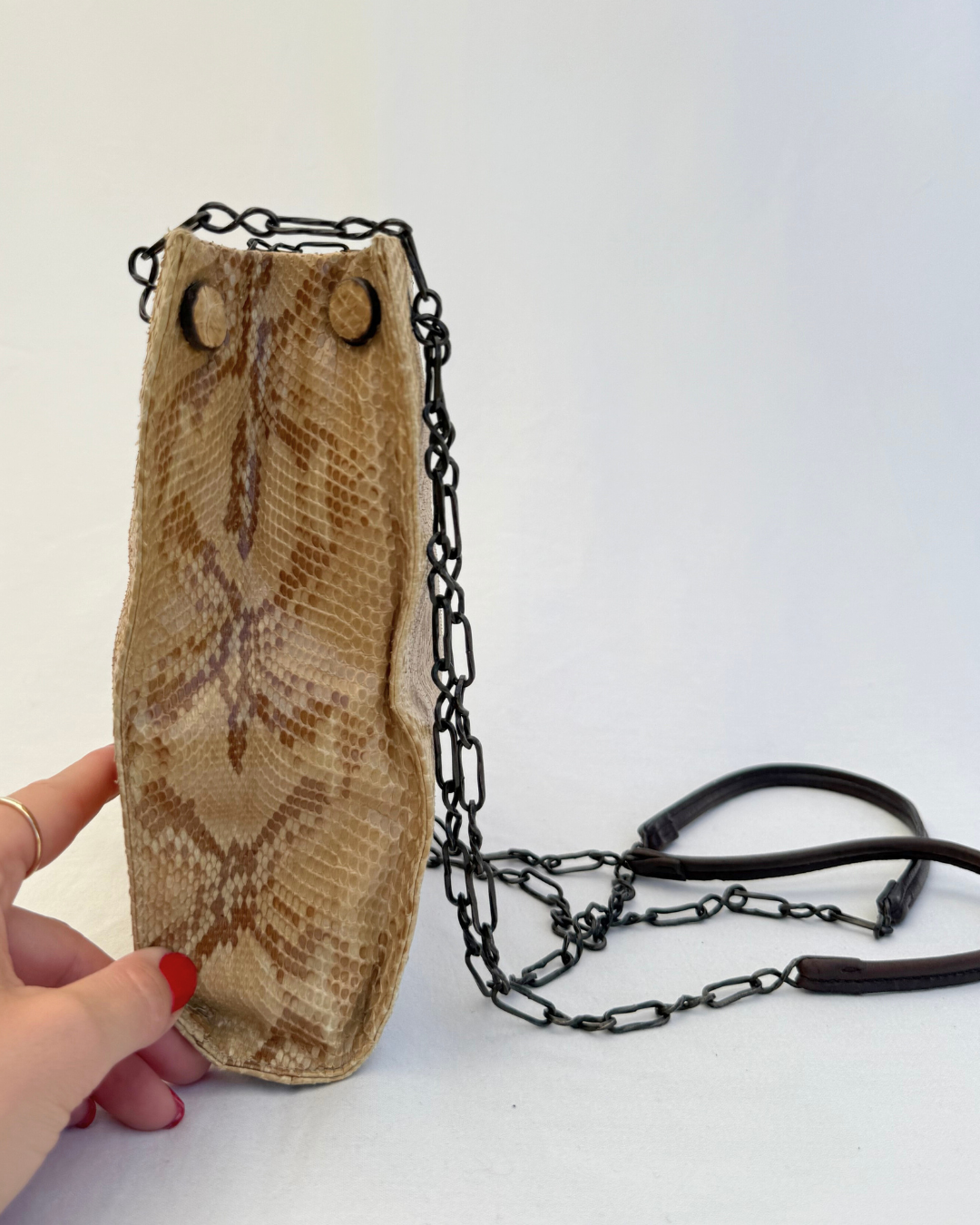 Side view of Prada Rare Vintage Enameled Metal Triangle Snakeskin Shoulder Bag on white background