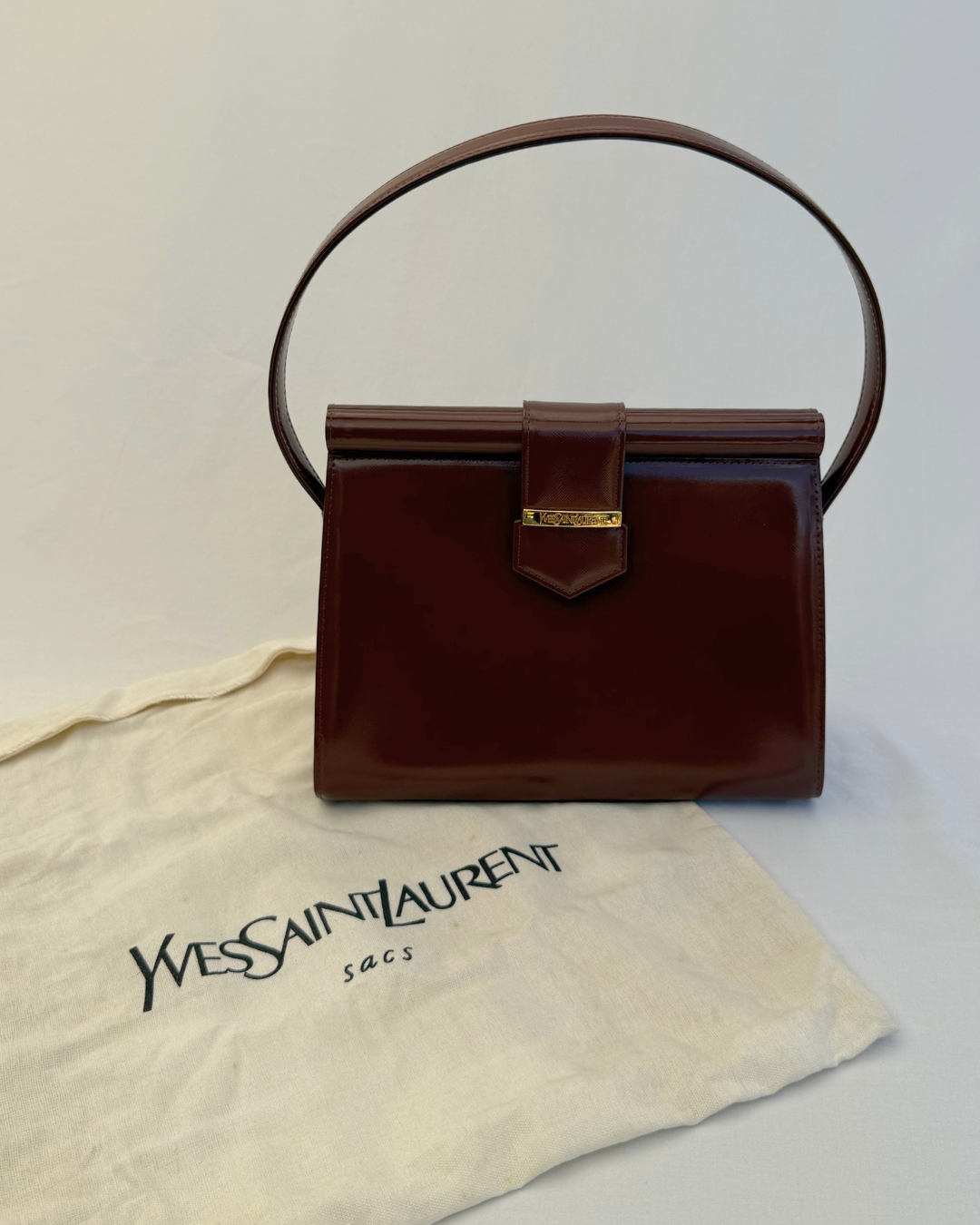 Front view Saint Laurent Vintage Brown Leather Shoulder Bag on white background with original dust cover